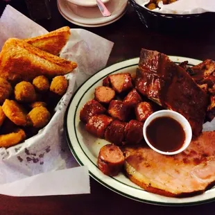  plate of meat, potatoes, and french fries