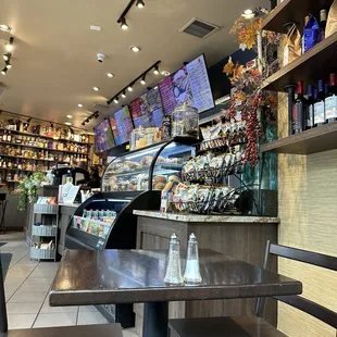 Chips, pastry case, menus above and liquor on the far wall.