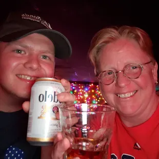  man and a woman holding a beer