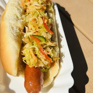 a hot dog in a bun with coleslaw