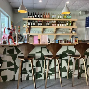 three stools in front of a bar