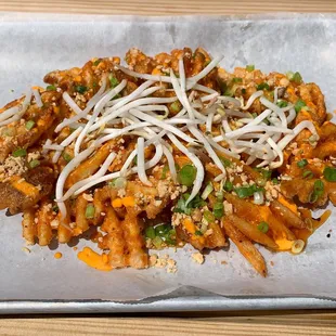 Pad Thai waffle fries with tamarind, sprouts, scallion, and peanuts