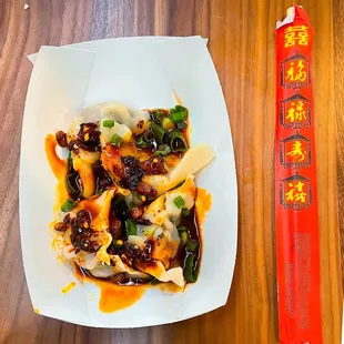 4 pieces of Dumplings $10 - chopsticks for size scale