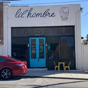 a red car parked in front of a store