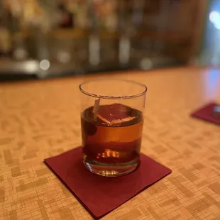 a glass of whiskey on a table