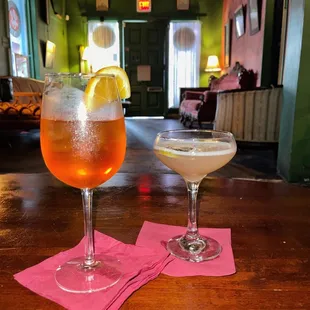 two cocktails on a wooden table