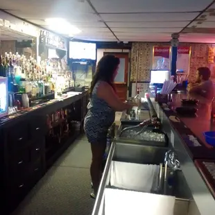  woman standing at the bar
