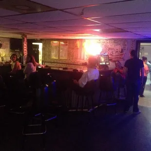  group of people sitting at a bar