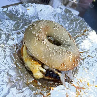 a bagel sandwich on aluminum foil