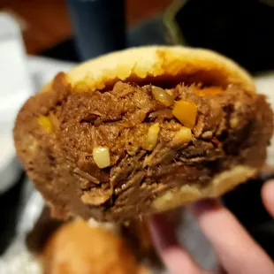 a hand holding a sandwich