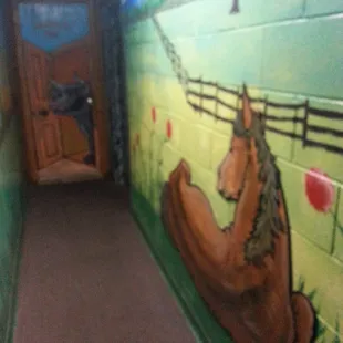Mural on all walls of hall to bathrooms