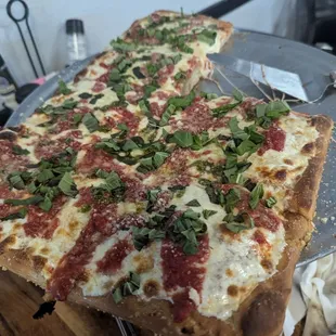 Grandma pizza, 2 slices already plated by our server.