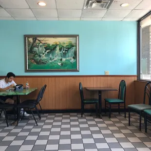 a woman sitting at a table in a restaurant