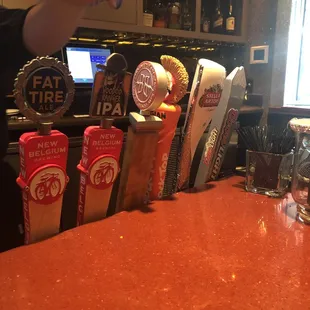 a person pouring a drink at a bar