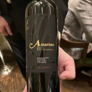 a person holding a bottle of wine