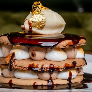 a stack of waffles with ice cream and chocolate sauce