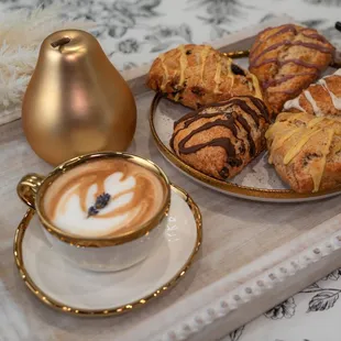 a tray of pastries and a cup of coffee