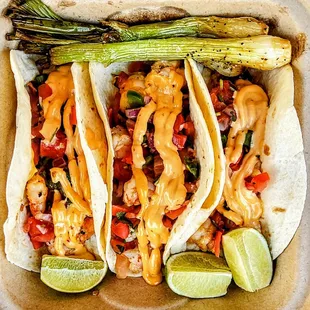 Shrimp Tacos: topped with chipotle sauce and pico de gallo. $11.95