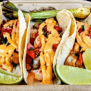 Shrimp Tacos: topped with chipotle sauce and pico de gallo. $11.95
