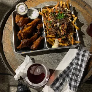 a tray of food and a glass of wine