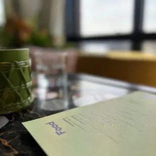 a glass of water and a note on a table