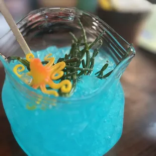 a blue drink with an octopus in it
