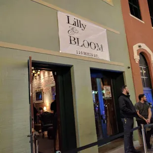 a group of people standing outside of a building