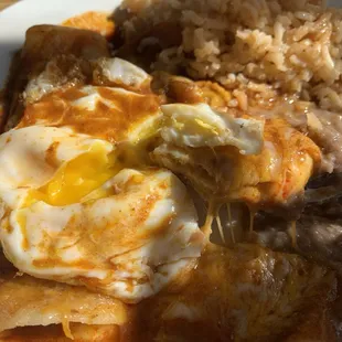 Eggs Rancheros - cheesy mole breakfast enchiladas served with eggs.