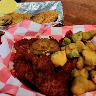 Hot Nashville chicken with fried okra and a side of fried green tomatoes