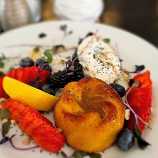 Honey and Cream Cake with berries, seeds, almond infused whip cream, and lemon honey