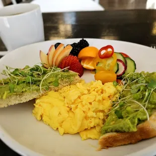 Avocado Toast and Eggs with house made sourdough toast, soft scrambled eggs, and fresh fruit