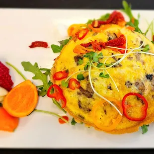 Frittata Primavera - cast iron roasted vegetables and eggs, baby greens, tarragon oil, and feta. Includes fruit.