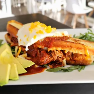 Madame Adovada - grilled butter brioche bread, cheddar and jack cheese, carne adovada, red chile, and basted egg