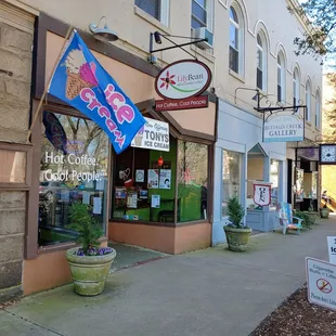 a sidewalk in front of a coffee shop