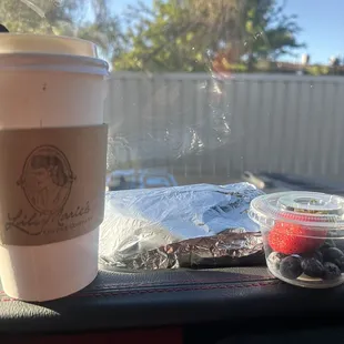 a cup of coffee on a car dashboard
