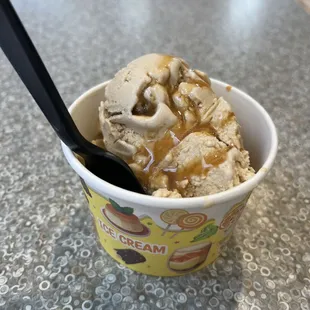 single scoop of coffee ice cream with caramel sauce