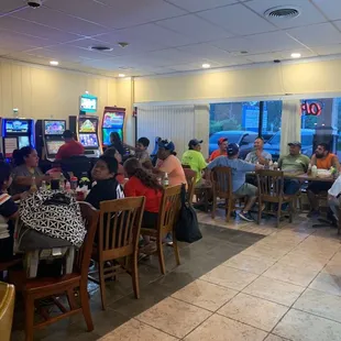 a large group of people eating in a restaurant