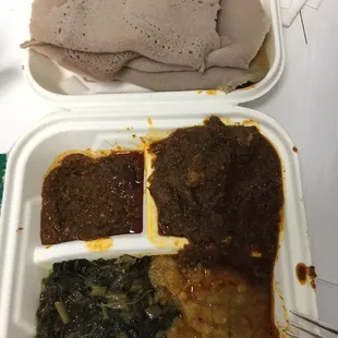 Yebeg (lamb) wat with miser (red lentils), shiro (chick peas) and gomen (collards) and a healthy serving of injera.