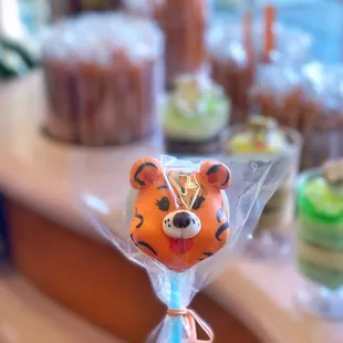 a hand holding a lollipop