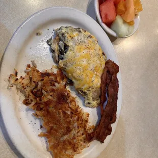 Mushroom and cheese omelette with a side of bacon, and fruit cup.