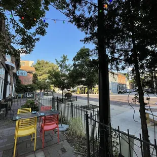 a street corner with tables and chairs