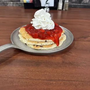 Chocolate chip pancakes with strawberries and whipped topping