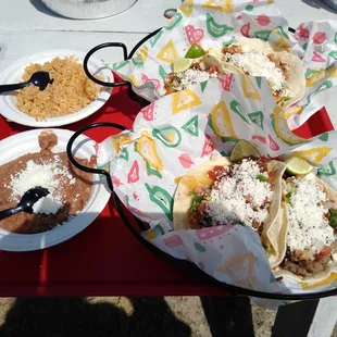 Tacos with flour tortillas (queso fresco added), an order of rice, order of beans