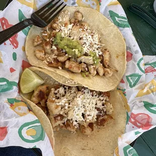 Chicken tacos with cheese and guacamole