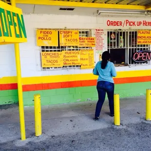 a woman standing in front of a restaurant
