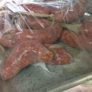 Fresh sausages and other meats in case to left of café section!