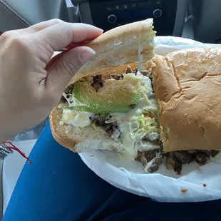 a person holding a sandwich