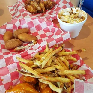 Honey habenaro with fresh cut fries in bottom basket. Caribbean Jerk in top basket. Bison chile  and jalapeño popers.