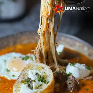 a bowl of soup with noodles and meat