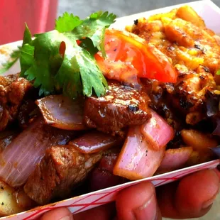 Our Lomo Saltado: Flat Iron Steak marinated in gluten free soy sauce and Peruvian spices, flame seared and served with potatoes.